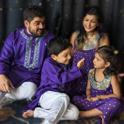 girl, boy, mother, father family twinning in festive Indian clothes