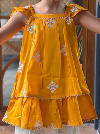 embroidery with sequins on a yellow ethnic kurti top for girls