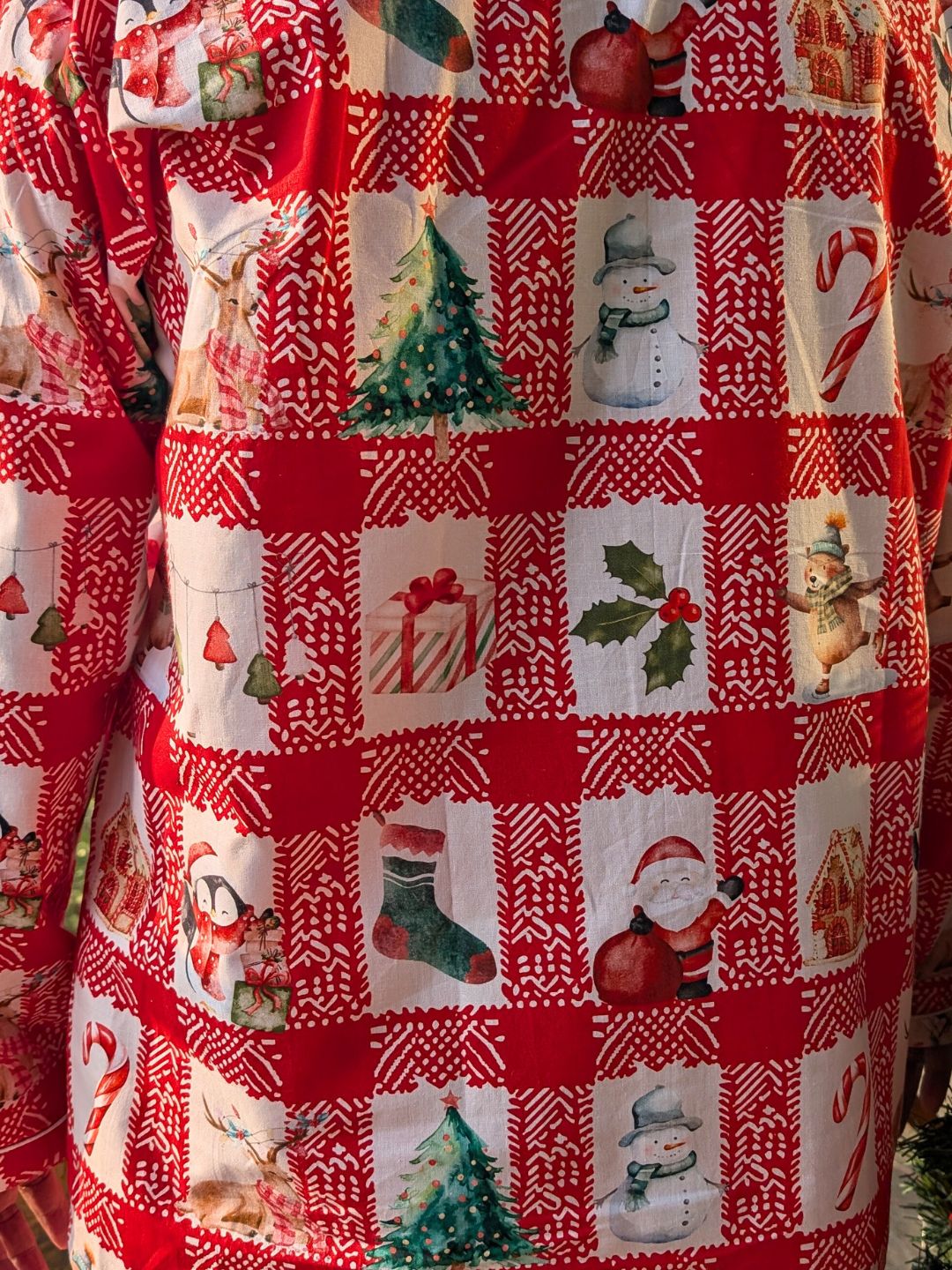 Red and white checked or chequed nightsuit printwith Christmas-themed patchwork design featuring trees, presents, mistletoe and Santa Claus.