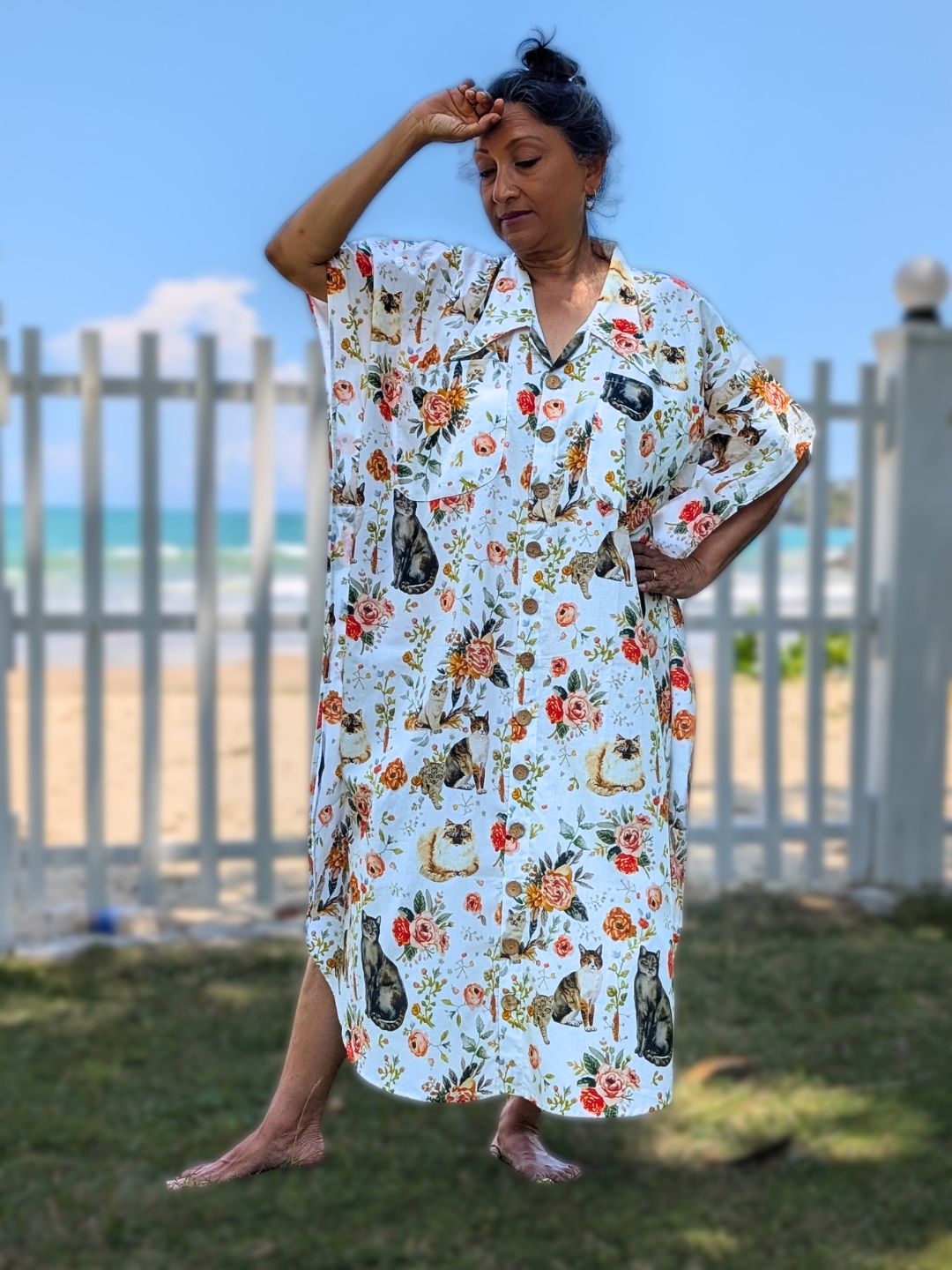 Woman wearing a floral kaftan shirt style dress with cat design