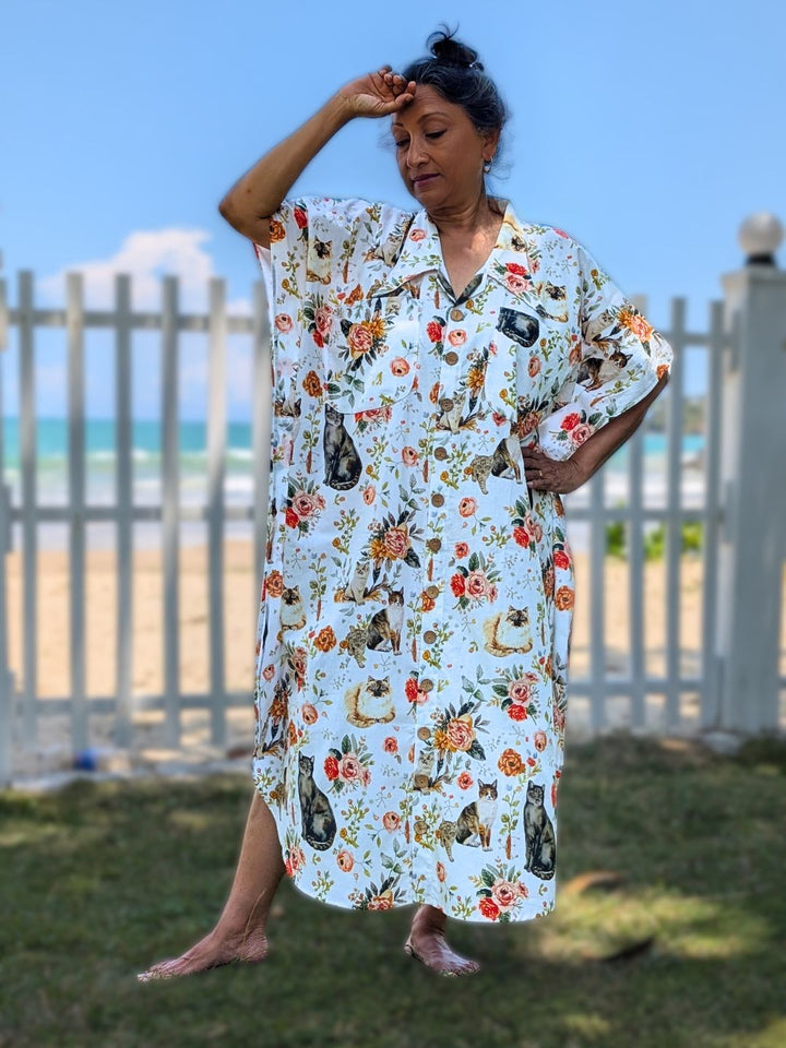 Woman wearing a floral kaftan shirt style dress with cat design