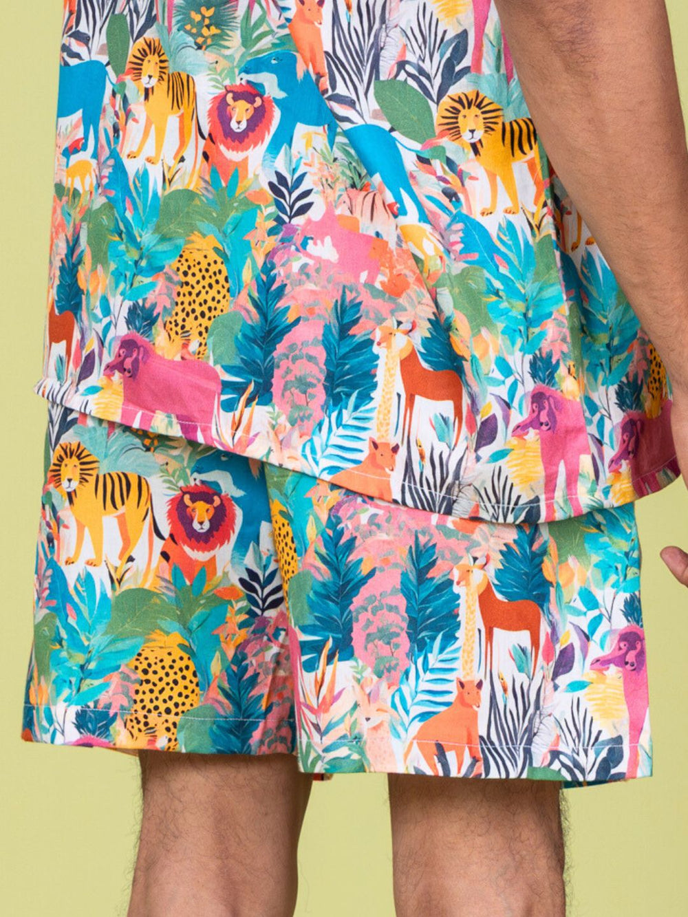Colorful mens shorts with animal and leaf pattern on a yellow background
