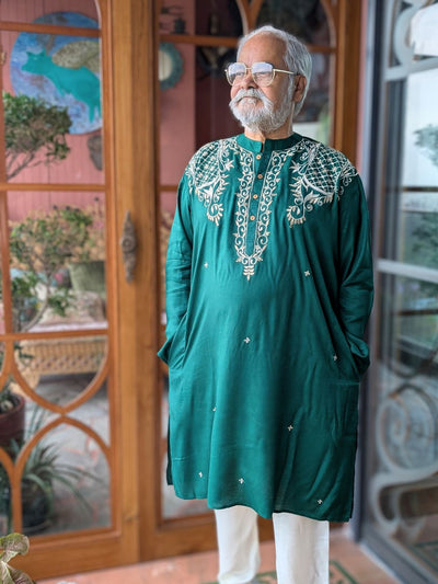 Man wearing a festive emerald green embroidered bengali style kurta 