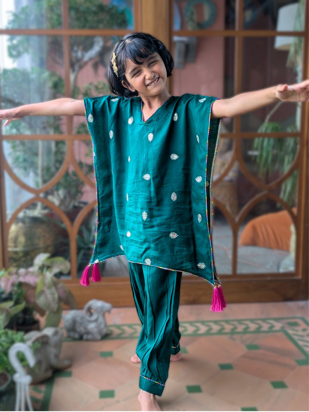 Child in an EMERALD GREEN traditional outfit with white embroidery, dressed for diwali 
