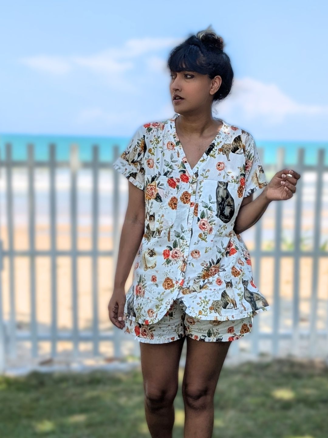 Woman wearing a floral cotton shirts and top with cat print 