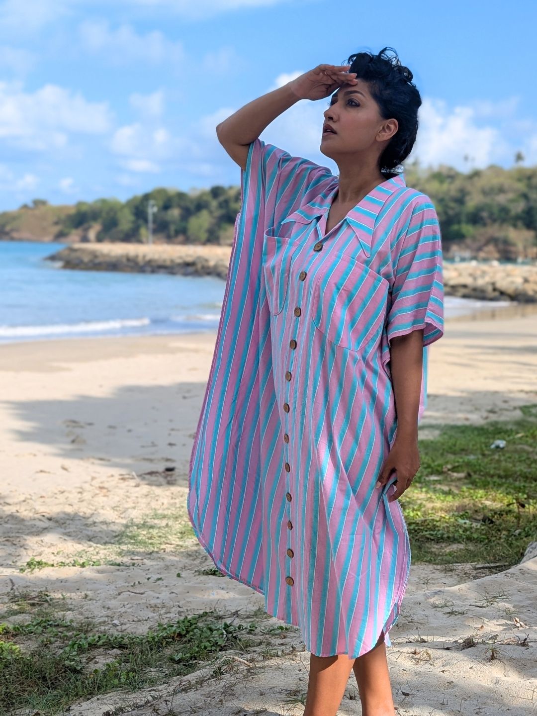 Woman in a pink and blue striped night shirt on vacation