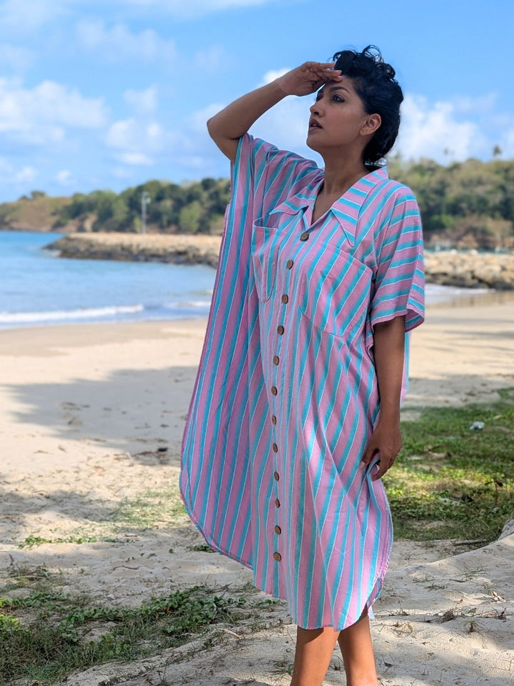 Woman in a pink and blue striped night shirt on vacation