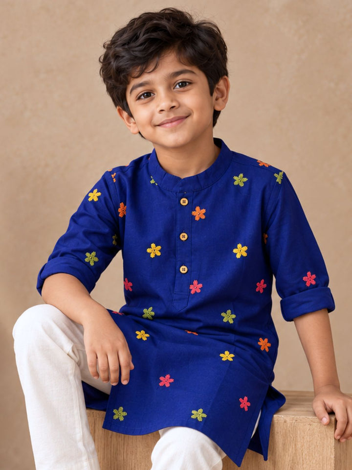 Boy wearing a dark blue festive kurta with multicolour kuchhi style embroidery, wooden buttons, for navratri and dussehra