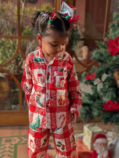 Child wearing a red and white Christmas-themed pajama set with a festive background.