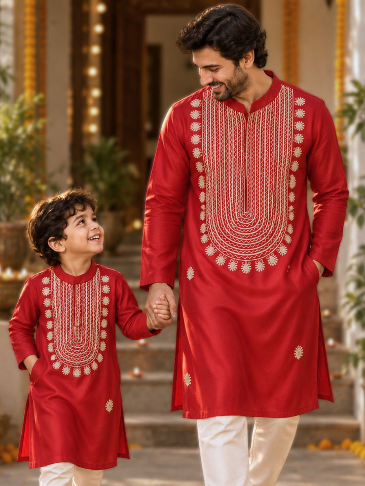 Boy and man in matching red cupro silk Tashan kurtas with beige-gold resham embroidery