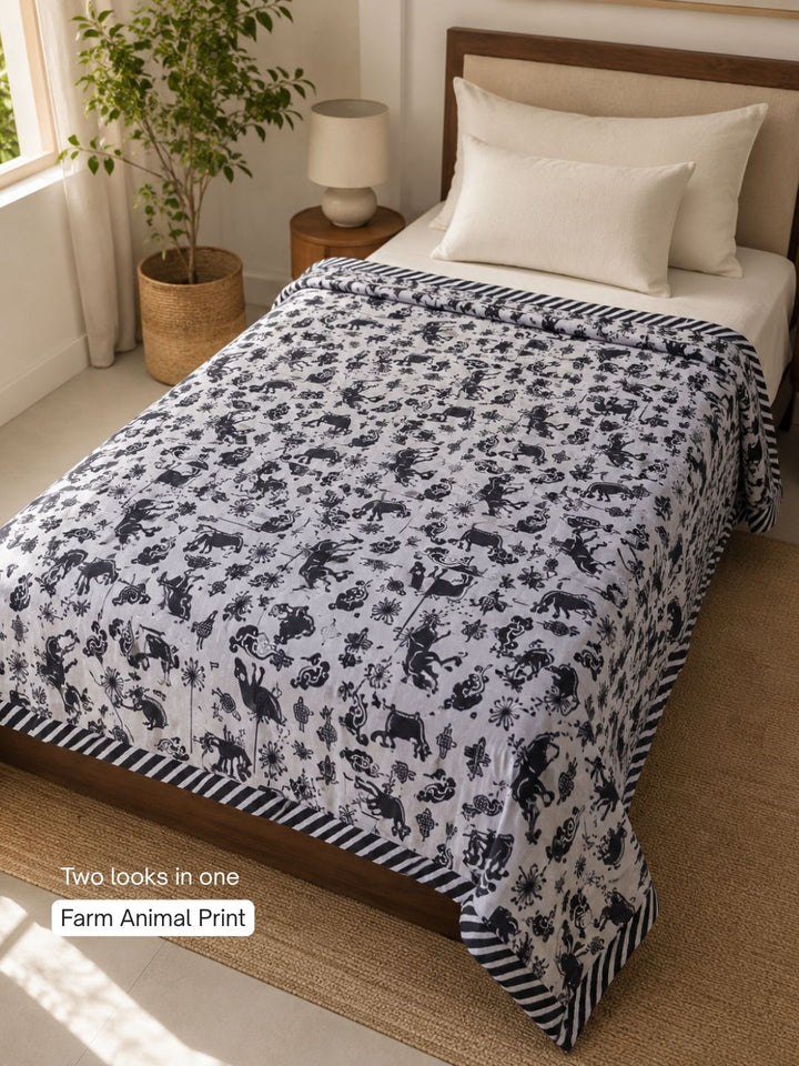 Farm-animal side of Tura Turi reversible cotton blanket - horses, shee, goat and folk motifs in black on a grey background