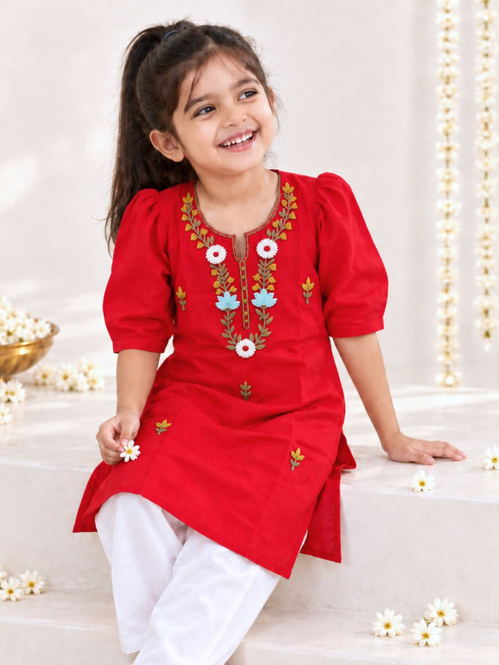girl wearing a red malmal muslin embroidered kurta 