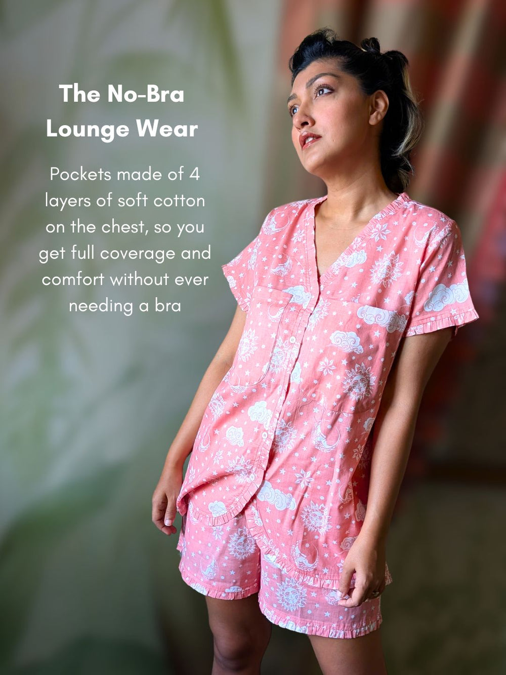 Woman wearing pink lounge wear with text about no-bra design