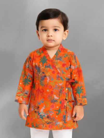 Child wearing an orange cotton floral kurta against a gray background