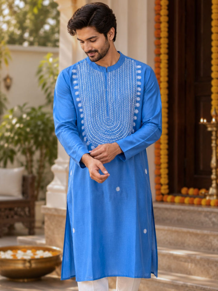 Man in French blue cupro silk Tashan kurta with white resham embroidery