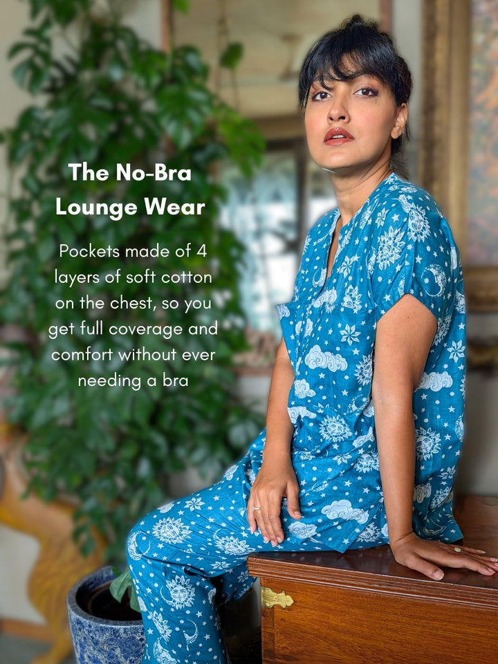 Woman wearing blue floral lounge wear sitting on a wooden bench with text about no-bra lounge wear.