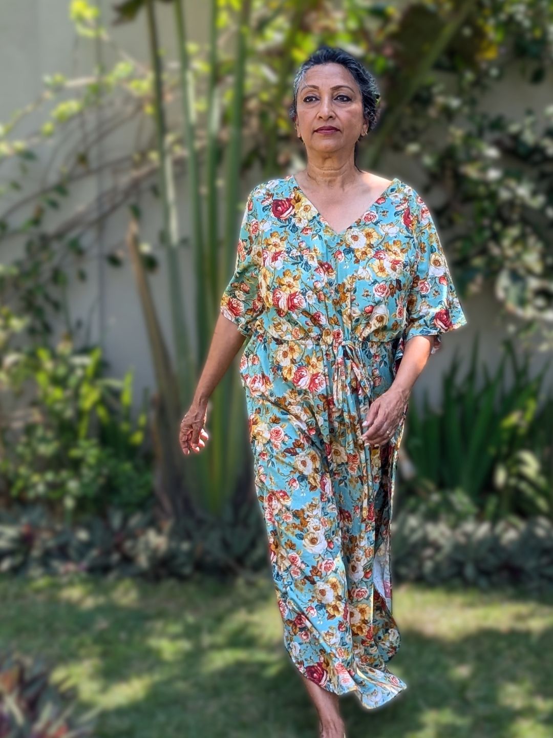 Woman in a cotton floral no bra kaftan nightie