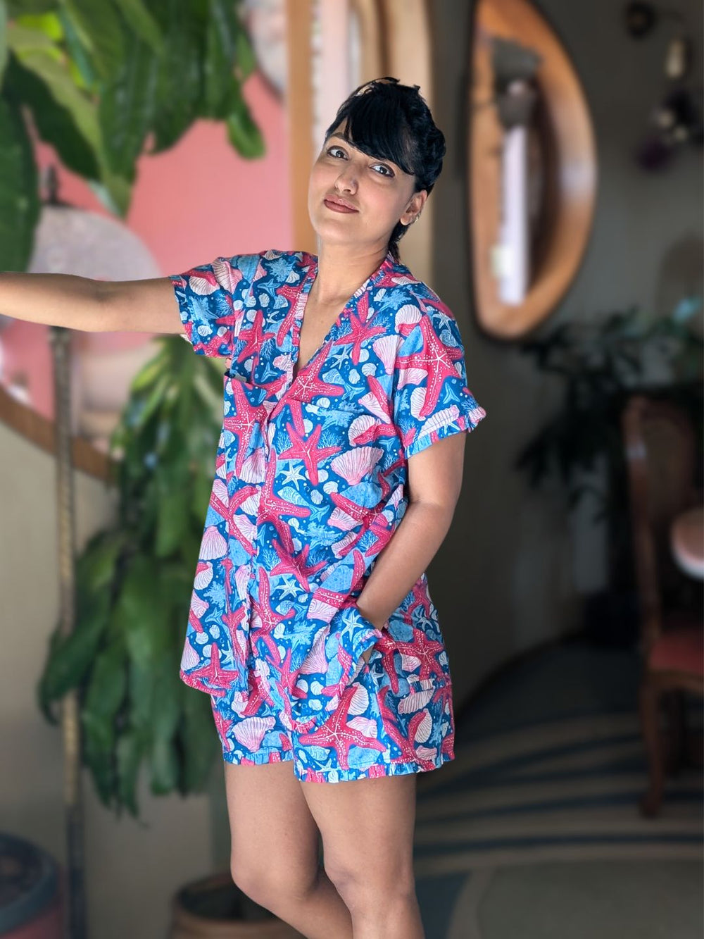 Woman wearing a blue ocean themed shorts and top set. casual summer loungewear