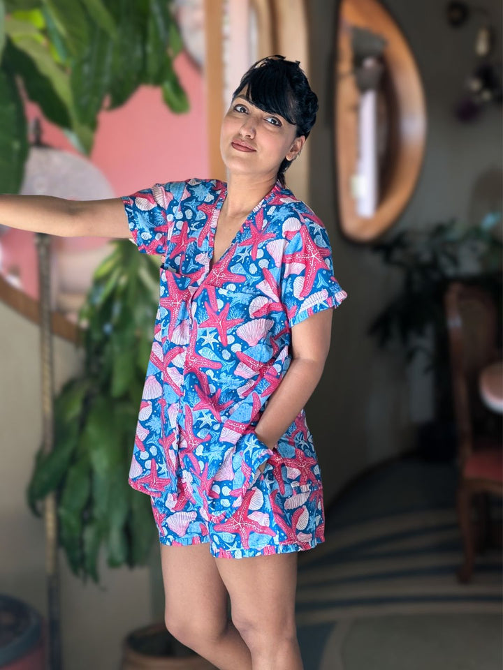 Woman wearing a blue ocean themed shorts and top set. casual summer loungewear