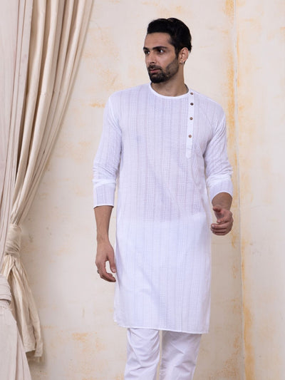 Man wearing a white kurta with a plain background