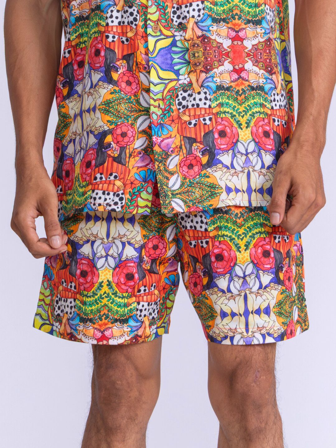 Colorful patterned cotton shorts worn by a man on a white background