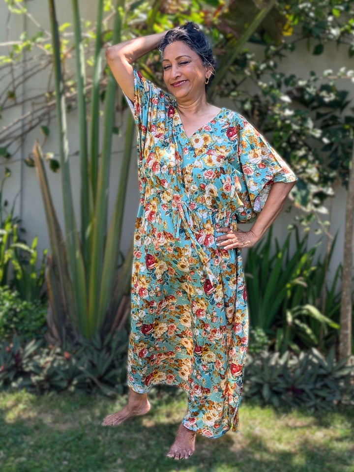 Woman in a cotton rose print no bra adjustable kaftan night dress