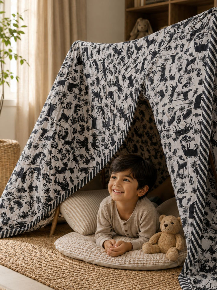 turaturi reversible blanket being used as a tent by a little child. cosy blanket that leads to endless playtime