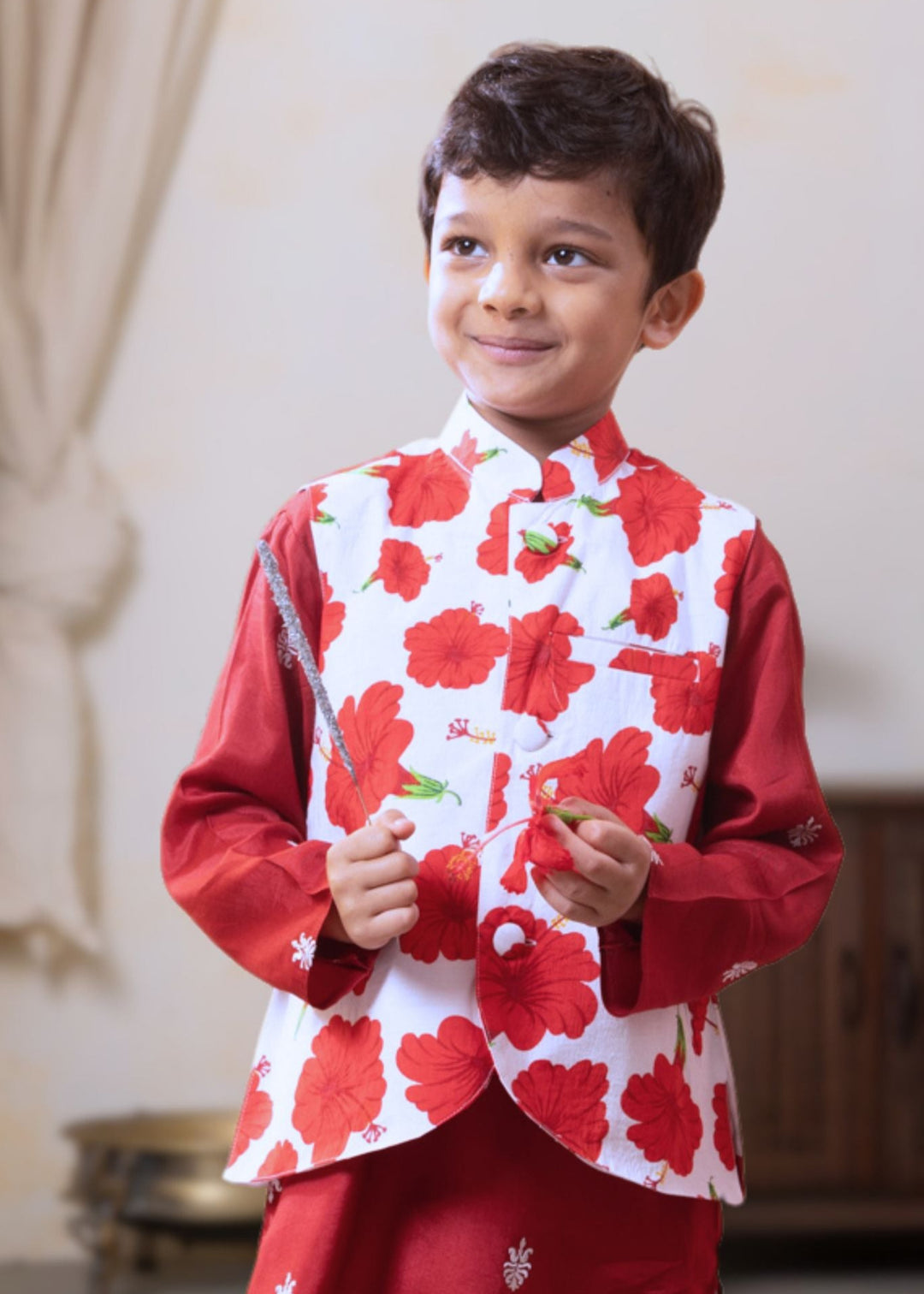 boy wearing festive indian modi jacket in red and white floral print