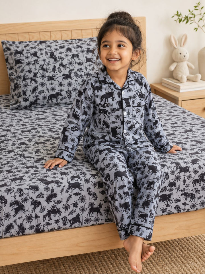 Black and grey farm themed cotton bedsheet for kids with matching pillow cover. child wearing matching nightsuit pajama set 