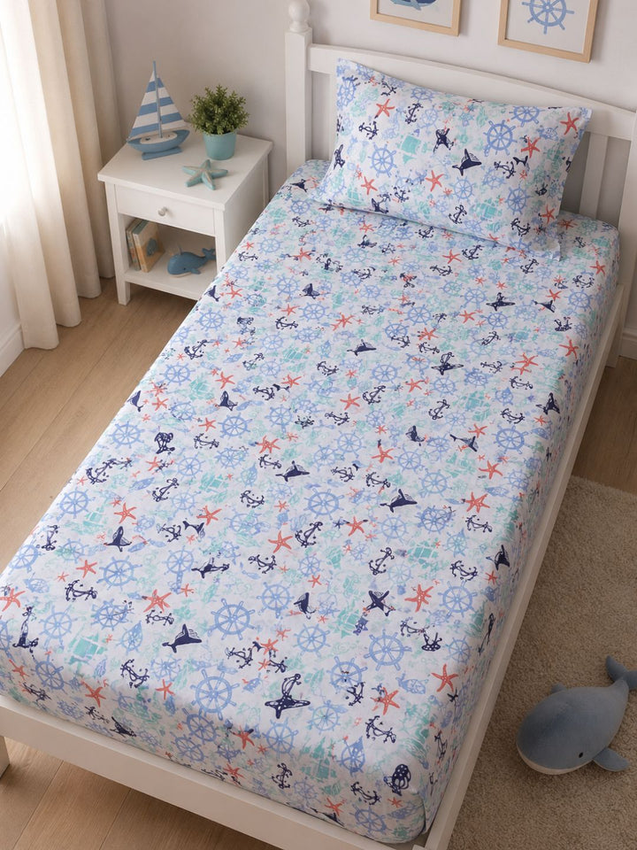 Kids ocean themed cotton bedsheet with matching pillow cover, styled on a single bed in a fresh sunlit room.