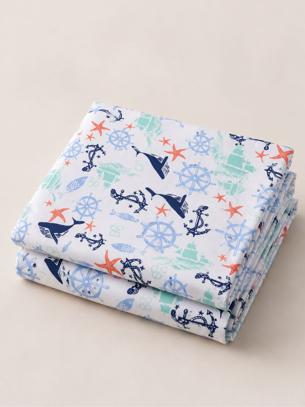 pure cotton folded bedsheet with nautical pattern on a beige background