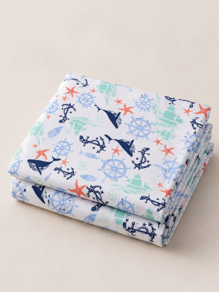 pure cotton folded bedsheet with nautical pattern on a beige background