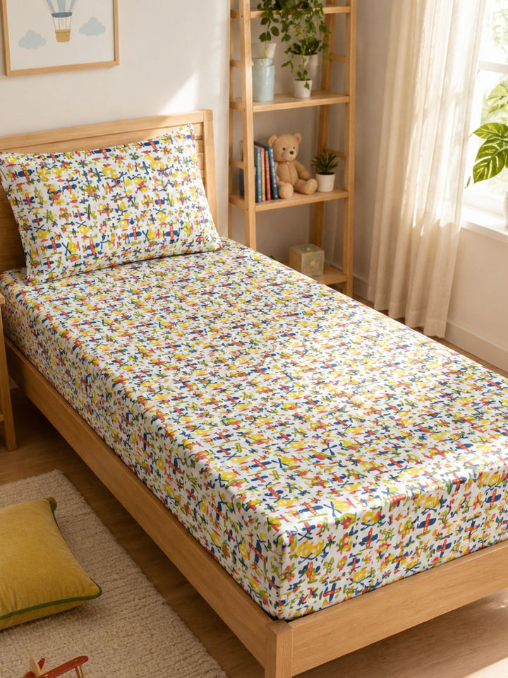 Cotton single bedsheet and pillowcase with playful aircraft print for boys and girls, styled in a cosy kids room.