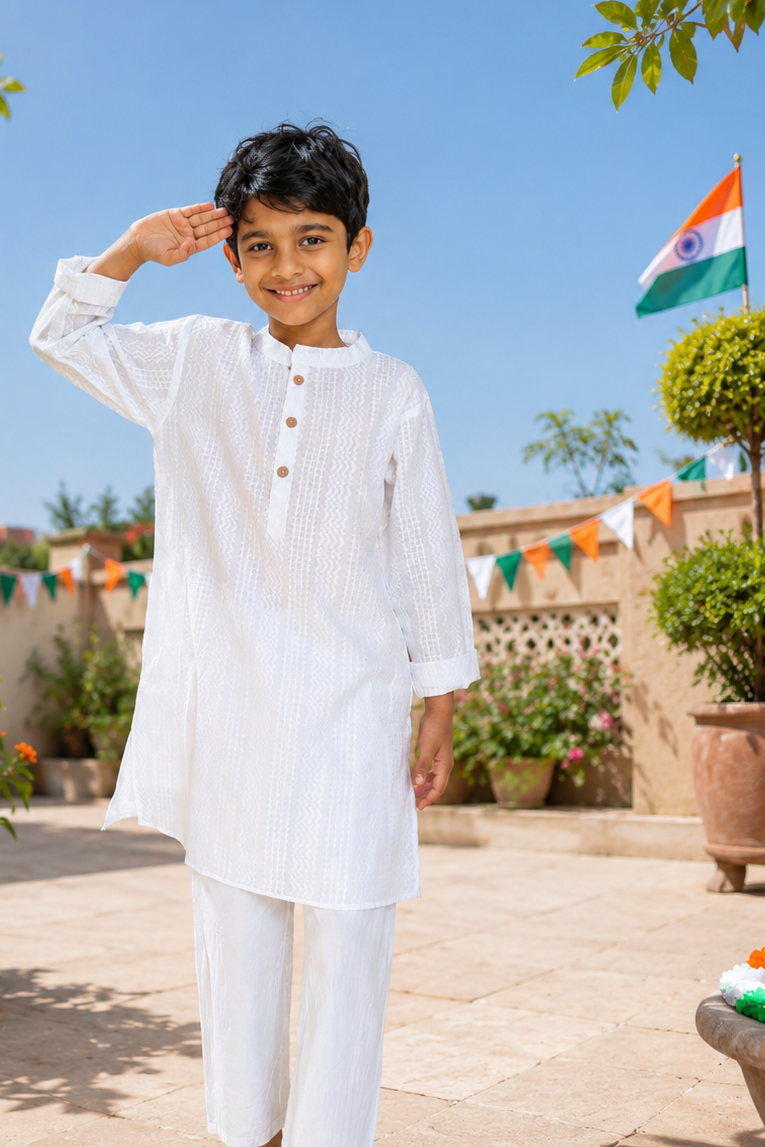 Boy in white self-design cotton kurta with Independence Day flag banners in the garden