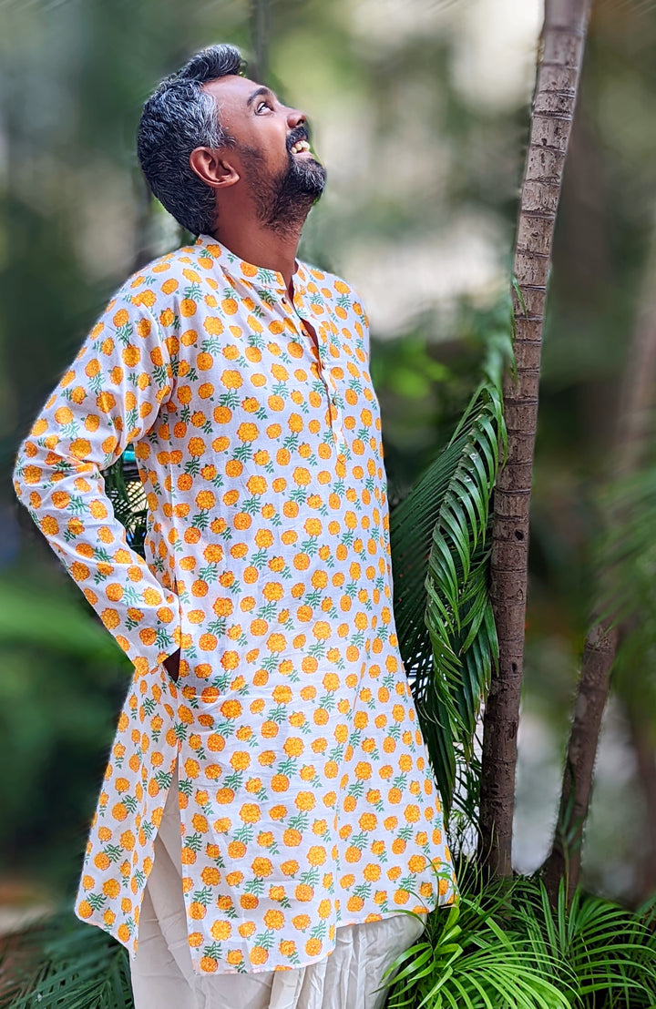 Father and son twinning in Marigold print cotton malmal kurtas