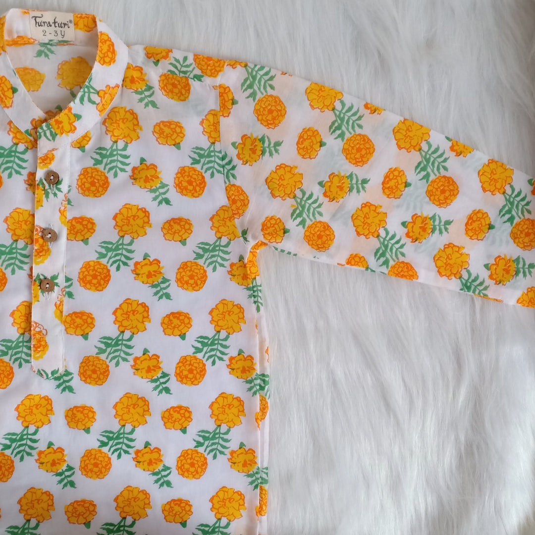 Marigold print malmal kurta laid flat showing wooden button placket