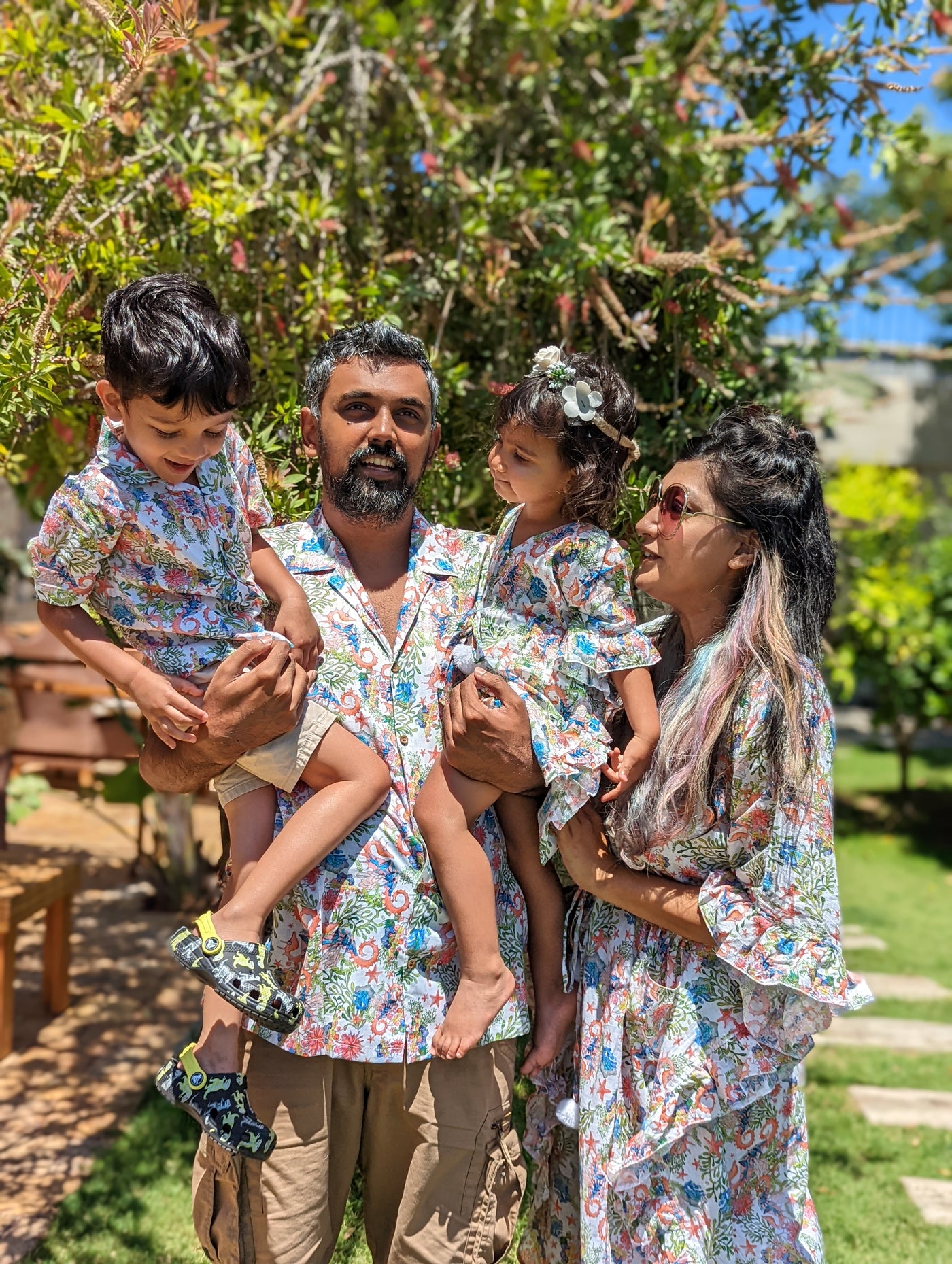 family twinning for beach vacation in beach shirt and kaftan